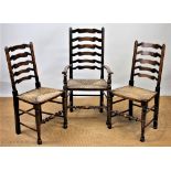 A set of eight stained beech ladder back dining chairs, including two with arms, with rush seats,