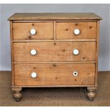 A late Victorian pine chest, of two short and two long drawers, with ceramic handles,