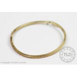 A 9ct yellow gold bangle, of plain square form, integral clasp with single safety catch,