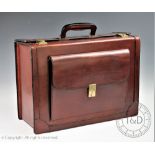 A tan leather pilots case, with front pouch and pale leather interior,
