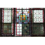 Five Victorian stained glass panels, including one decorated with a bird to the centre,