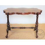 A Victorian rosewood stretcher table, with serpentine top, on turned and fluted uprights,