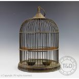 An Edwardian brass dome top bird cage with suspending loop, 45cm high with a J.W.