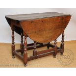 An 18th century oak gate leg table, with drawer, on turned and block legs,