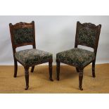 A set of eight late Victorian carved walnut dining chairs, with upholstered backs and seats,
