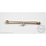 A diamond solitaire tie pin, set with a central cushion shaped,