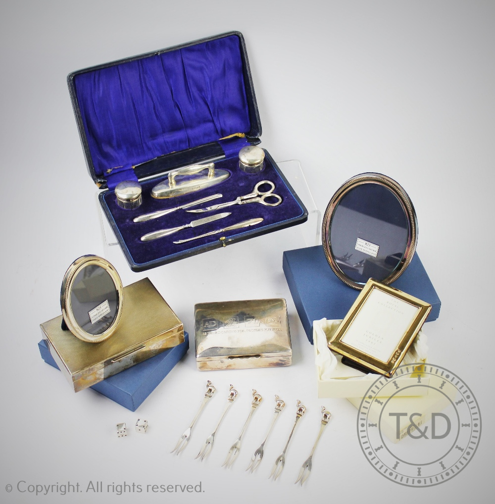 A cased silver manicure set, Chester 1920, to include, silver topped jars, buffers, tools,