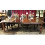 A late 19th century and later mahogany extending dining table, the top with a moulded edge,