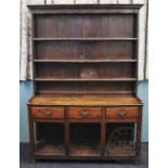 A George III oak dresser, raised back with moulded cornice and three shelves,