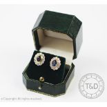 A pair of sapphire and diamond cluster earrings, designed as a central oval sapphire,