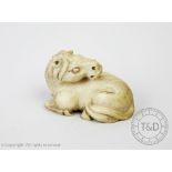 A Japanese carved ivory netsuke, Meiji period, carved a recumbent horse, signed to the underside,