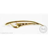 A diamond set modernist brooch, of tapering, plain polished form and set with three graduated,