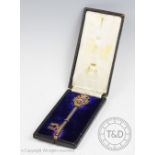 A silver gilt and enamel presentation key, Fattorini & Sons, Birmingham 1909,