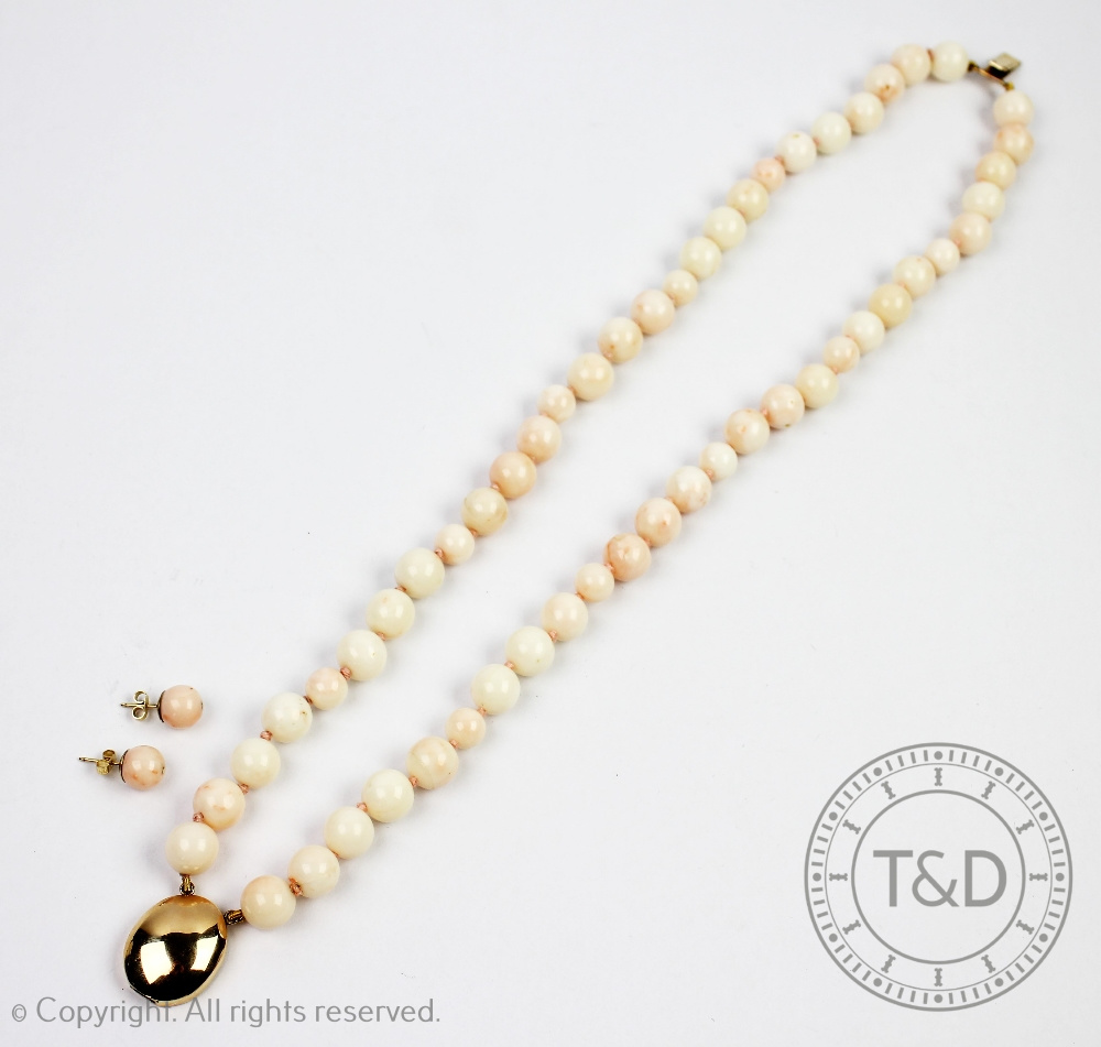 A two strand pale coral bead necklace with 14ct gold clasp 37.