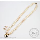A two strand pale coral bead necklace with 14ct gold clasp 37.