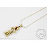 A ruby and diamond pendant and chain, of double gourd shape and within a diamond set surround,