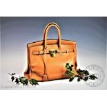 An Hermes Birkin 35 in caramel clemence leather, with gold coloured hardware,