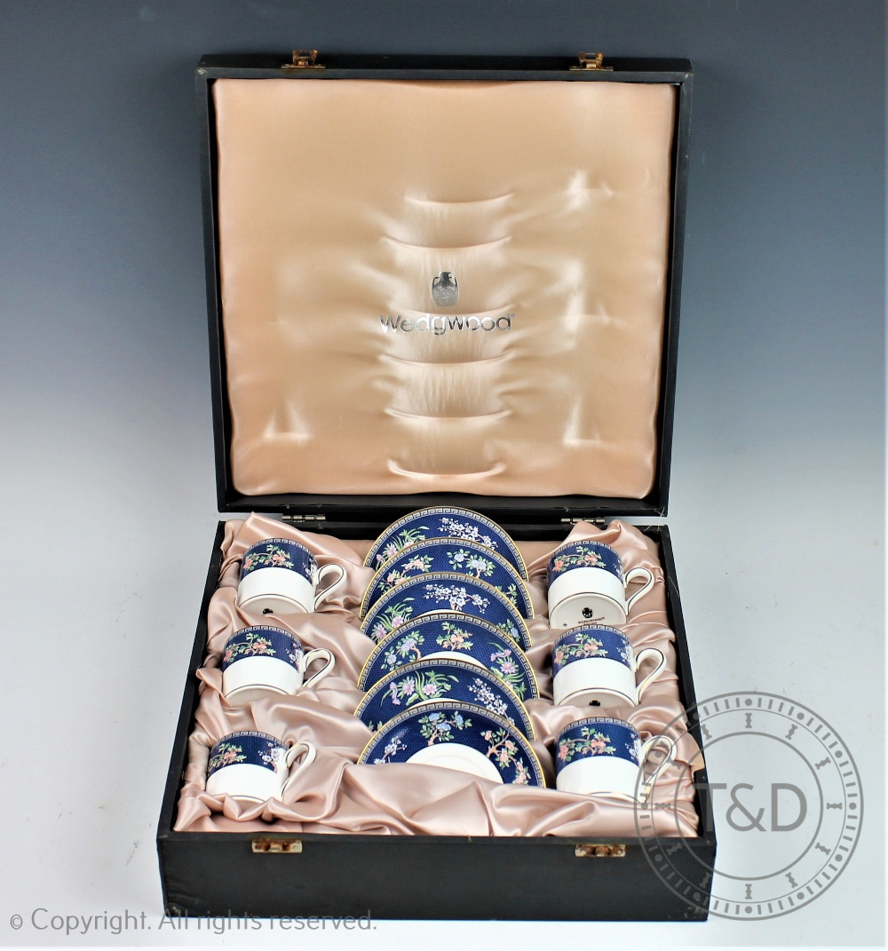 A case Wedgwood coffee service in the Blue Siam pattern comprising six coffee cups and saucers,