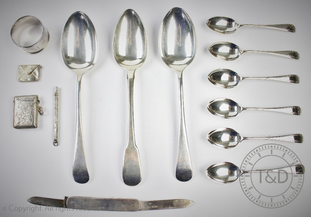 A cased set of six silver tea spoons, Sheffield 1923, with three silver table spoons,