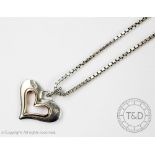 A Clogau heart pendant and attached chain,