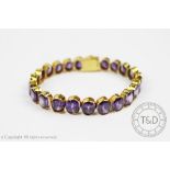 An amethyst graduated line bracelet, designed as twenty three graduated oval amethysts,