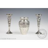 A pair of early 20th century white metal posy vases,
