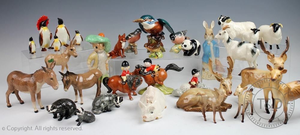 A collection of Beswick and Royal Doulton animals to include three Beswick donkeys,