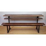 A vintage pitch pine and cast iron school desk, of long proportions, with four ink well apertures,