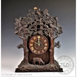 A later 19th century Black Forest carved wood twin fusee cuckoo clock,