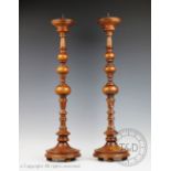 A pair of modern oak pricket altar type sticks, on circular bases,