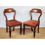 A pair of Victorian walnut side chairs, with foliate red upholstery,