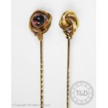 A snake stickpin, designed as a cabochon stone with entwined and coiled snake with textured finish,
