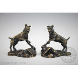 After Édouard Drouot (French 1859-1945), a pair of bronze terriers on rocky outcrops, each signed,