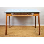 A late 1950's retro beech kitchen table, gingham style top with a metal trim, on tapered legs,