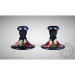 A pair of Moorcroft Anemnone pattern candlesticks, 9cm high, and Beswick stag,