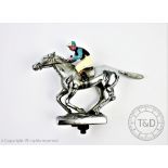 A novelty chrome car mascot in the form of a horse and jockey, with painted detailing,