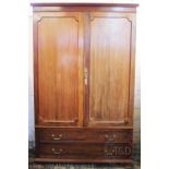 A 19th century mahogany wardrobe, with two doors above a long drawer, on bracket feet,