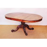 A 19th century and later mahogany extending dining table, the circular top with one spare leaf,