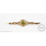 A peridot and seed pearl set brooch,