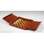 A late Victorian / Edwardian mahogany cased travelling chess set,