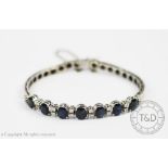 A sapphire and diamond bracelet, designed as seven sapphires,