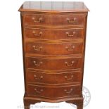 A reproduction mahogany serpentine pillar chest, with six graduated long drawers, on bracket feet,