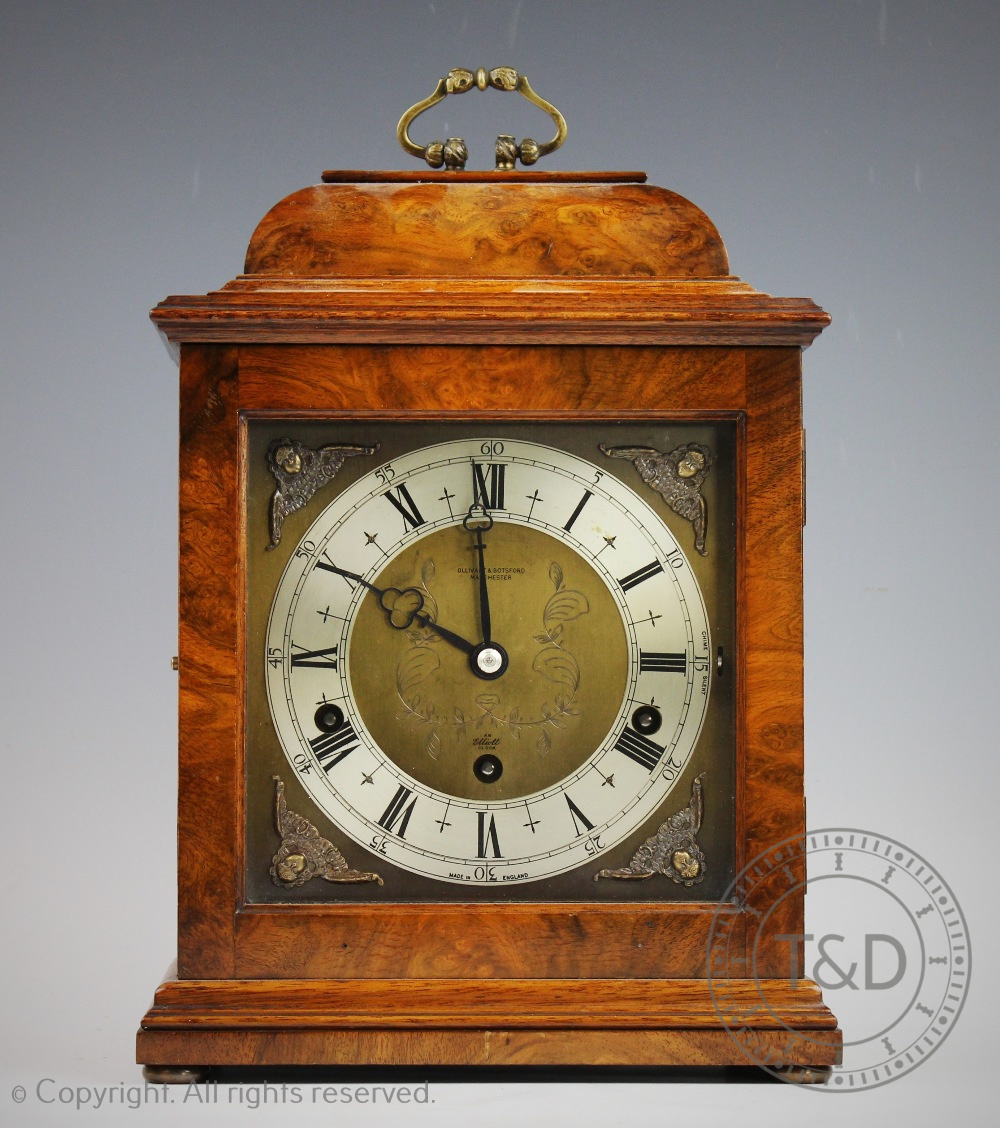 An Elliot walnut quarter chiming mantel clock retailed by Ollivant & Botsford of Manchester,