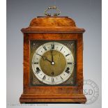 An Elliot walnut quarter chiming mantel clock retailed by Ollivant & Botsford of Manchester,