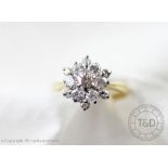 A diamond cluster ring of snowflake form,