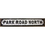 A cast iron road sign 'Park Road North', on ply wood back plate,