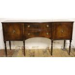 A reproduction mahogany serpentine side board, with two drawers and two cupboard doors,