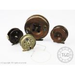 Four assorted fishing reels comprising two early 20th century wooden examples, largest,