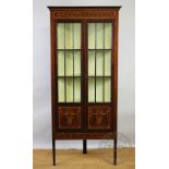 An Edwardian inlaid mahogany corner cabinet in the manner of Edwards and Roberts,