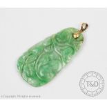 A carved jade pendant, of tapering form and depicting fruit and foliage,